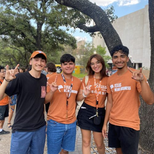 Students in orange McCombs shirts